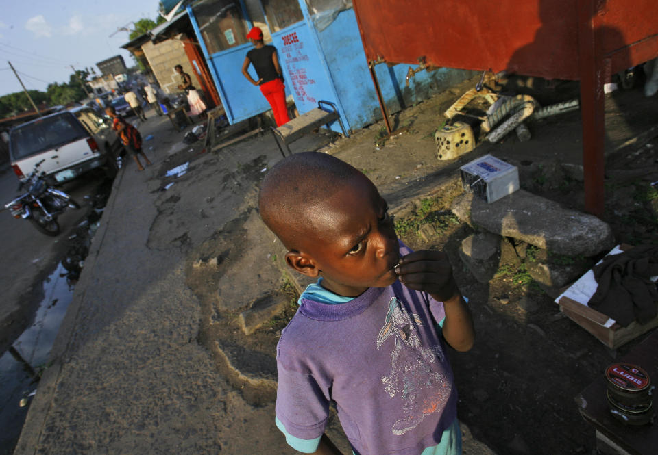 FILE - A young boy stands in the streets of Monrovia, Liberia, Nov. 20, 2007. Liberia is celebrating two major anniversaries this year — 200 years ago freed slaves from the U.S. arrived here and 25 years later they declared the country to be independent. Amid the festivities for Independence Day on Tuesday July 26, 2022, many Liberians say the West African country's promise is unfulfilled and too many of its people still live in poverty. (AP Photo/Jerome Delay, File)