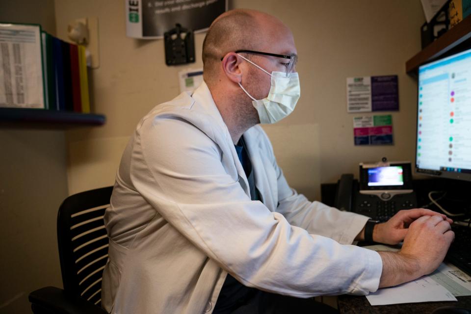 Emergency room Dr. Shawn Sloan chooses to wear a mask during his shift at Trinity Health Oakland Hospital in Pontiac even after the hospital relaxed its masking mandates on April 21, 2023. Sloan's wife was expecting their firstborn and he is hyper-focused on not bringing any unnecessary germs home.