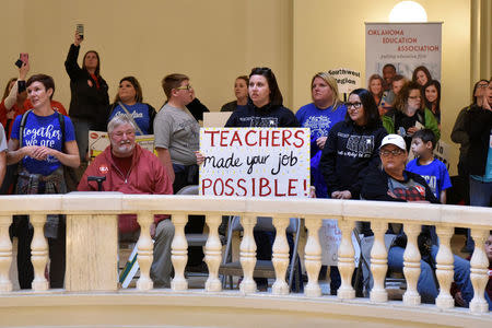 Teachers rally inside of the state Capitol rotunda on the second day of a teacher walkout to demand higher pay and more funding for education in Oklahoma City, Oklahoma, U.S., April 3, 2018. REUTERS/Nick Oxford