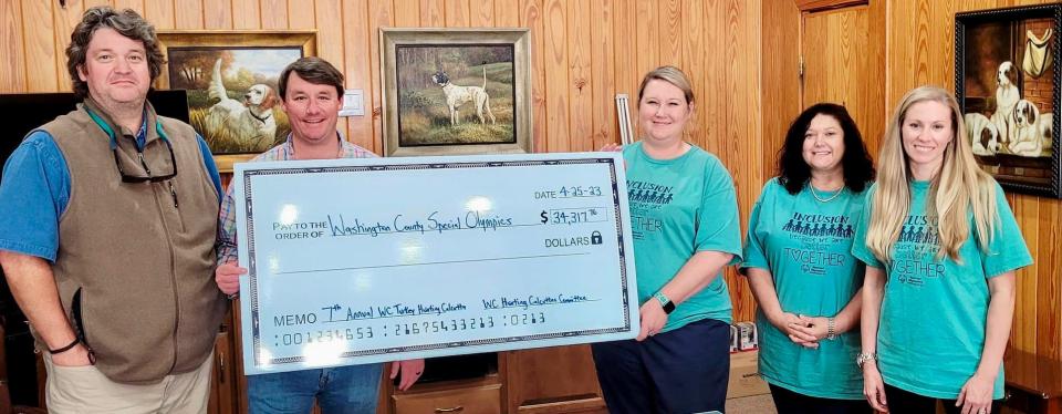 From left, Caldwell Adams and Zac Turner present proceeds from the Washington County Turkey Hunting Calcutta event to Cristie Giles, Christy Sullivan and Jessica Odom on April 25, 2023, in southwest Alabama.