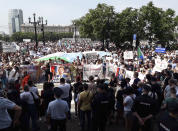 People hold posters reading "Freedom for Sergei Furgal, I'm, we are Sergei Furgal, "Give us Furgal back," "Call Furgal home" during an unsanctioned protest in support of Furgal, the governor of the Khabarovsk region, who was interrogated ordered held in jail for two months, in Khabarovsk, 6,100 kilometers (3,800 miles) east of Moscow, Russia, Saturday, July 18, 2020. Thousands of demonstrators in the Russian Far East city of Khabarovsk gather to protest against the arrest of the region's governor on charges of involvement in multiple murders. (AP Photo/Igor Volkov)