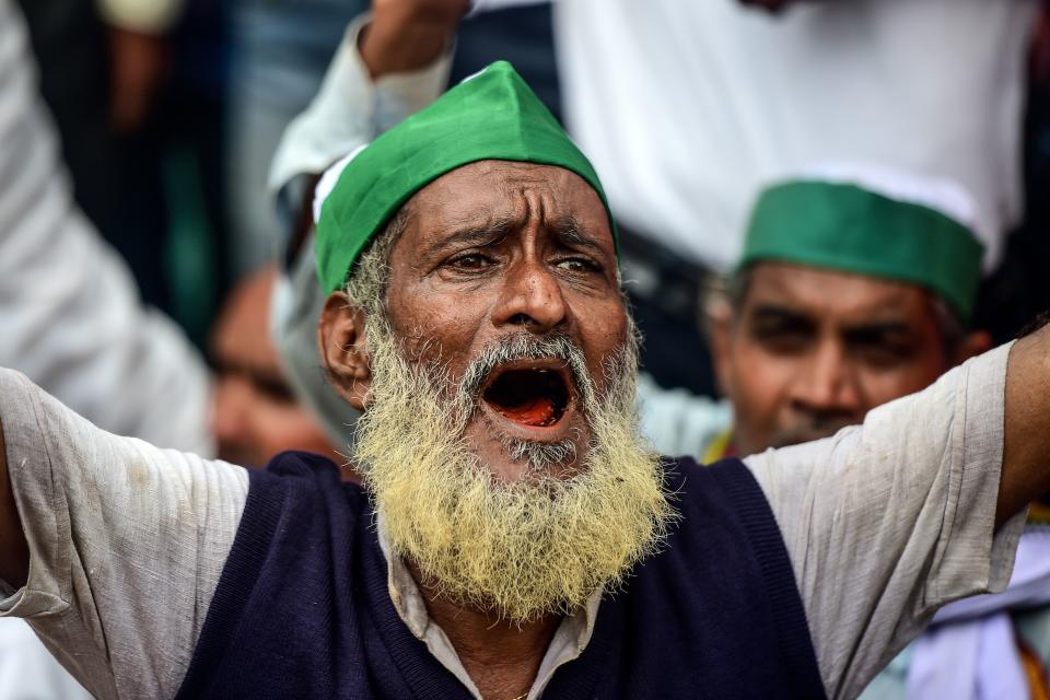 A farmer of the Bharatiya Kisan Union (BKU) - Indian Farmers' Union shouts slogans against Indian Prime Minister Narendra Modi's government during a nationwide farmers' strike following the recent passing of agriculture bills in the Lok Sabha (lower house), in Allahabad on September 25, 2020. (Photo by SANJAY KANOJIA/AFP via Getty Images)