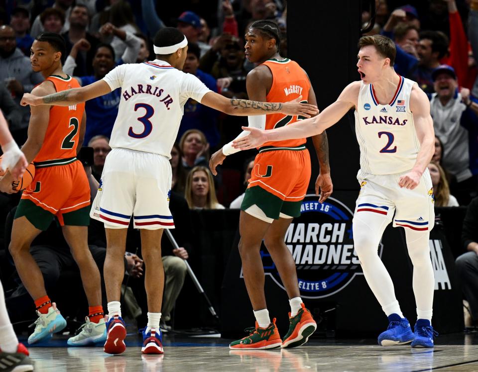 Kansas guards Dajuan Harris Jr. (3) and Christian Braun (2) celebrate during the second half of an NCAA tournament victory against Miami on March 27, 2022 in Chicago.