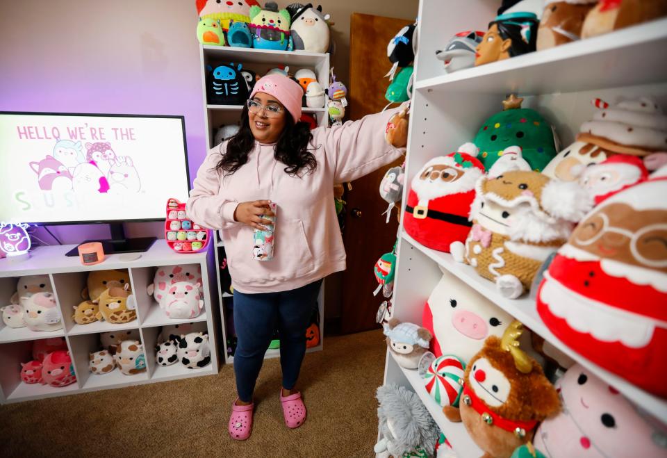 Hailey Porter, 31, talks about her Squishmallows collection, with more than 300 of the soft, colorful toys in her home office on Tuesday, Aug. 22, 2023.