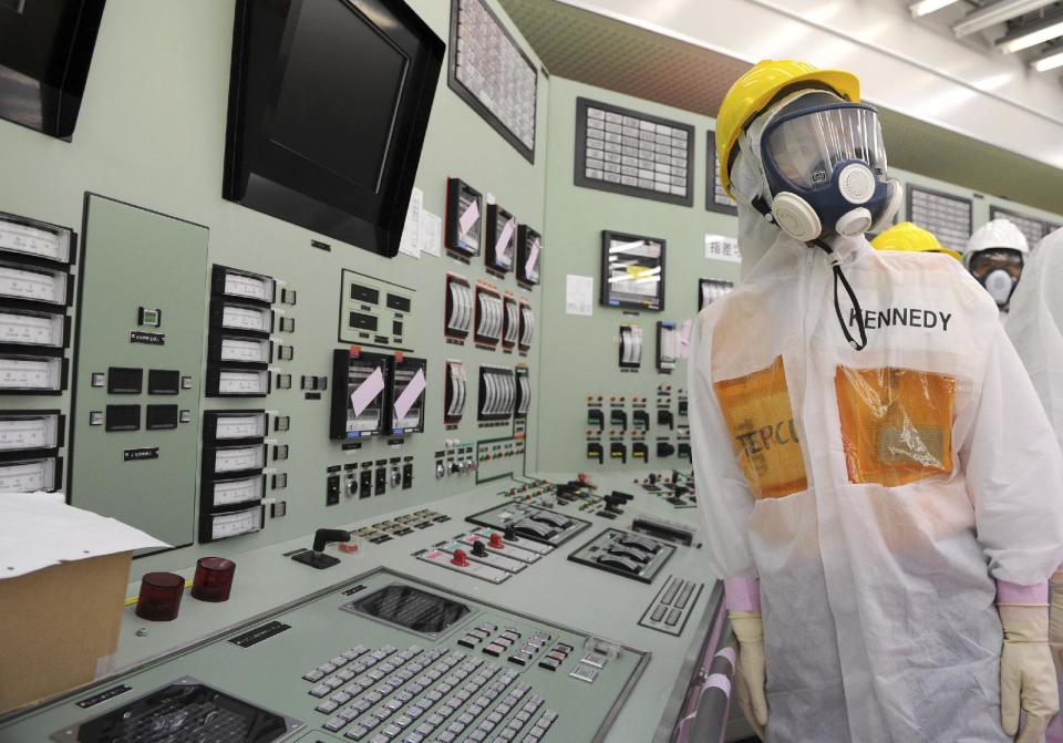 U.S. Ambassador to Japan Caroline Kennedy, wearing a helmet, protective suit and mask, inspects the central control room for the Unit One and Unit Two reactors of the tsunami-crippled Fukushima Dai-ichi nuclear power plant, operated by Japan's Tokyo Electric Power Co. (TEPCO), in Okuma, Fukushima Prefecture, northeastern Japan, Wednesday, May 14, 2014. Kennedy toured the plant for about three hours with her son, Jack Schlossberg. (AP Photo/Toru Yamanaka, Pool)