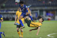 Australia's Chris Ikonomidis and Chinese Taipei's Lin Ming-Wei, top, fight for the ball during the World Cup 2022 Group B qualifying soccer match between Chinese Taipei and Australia in Kuwait City, Kuwait, Monday, June 7, 2021. (AP Photo/Jaber Abdulkhaleg)