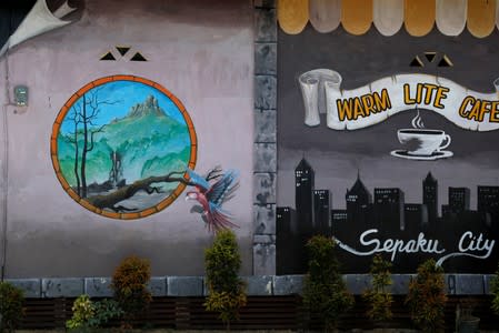 Murals are pictured outside a coffee shop at Sepaku district in North Penajam Paser regency, East Kalimantan province