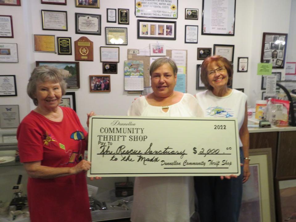 Dunnellon Community Thrift Shop volunteer Joann McCullough, left, presents a $2,000 check to Dori LoPriore, of the Rescue Sanctuary to the Maxx, and her friend Cynthia Marks.