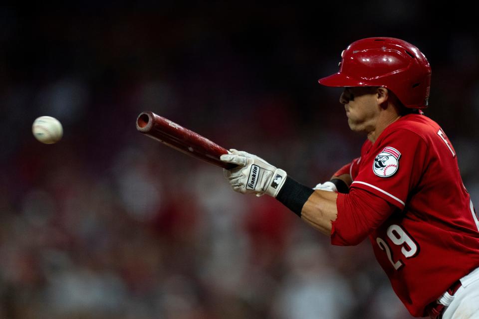 Cincinnati Reds left fielder TJ Friedl (29) bunts in the sixth inning of the MLB baseball game between the Cincinnati Reds and the Cleveland Guardians at Great American Ball Park in Cincinnati on Wednesday, Aug. 16, 2023. 
