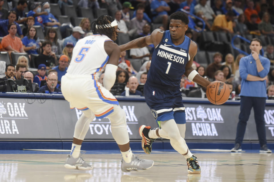Minnesota Timberwolves forward Anthony Edwards (1) tries to push past Oklahoma City Thunder forward Luguentz Dort (5) in the first half of an NBA basketball game, Sunday, Oct. 23, 2022, in Oklahoma City. (AP Photo/Kyle Phillips)