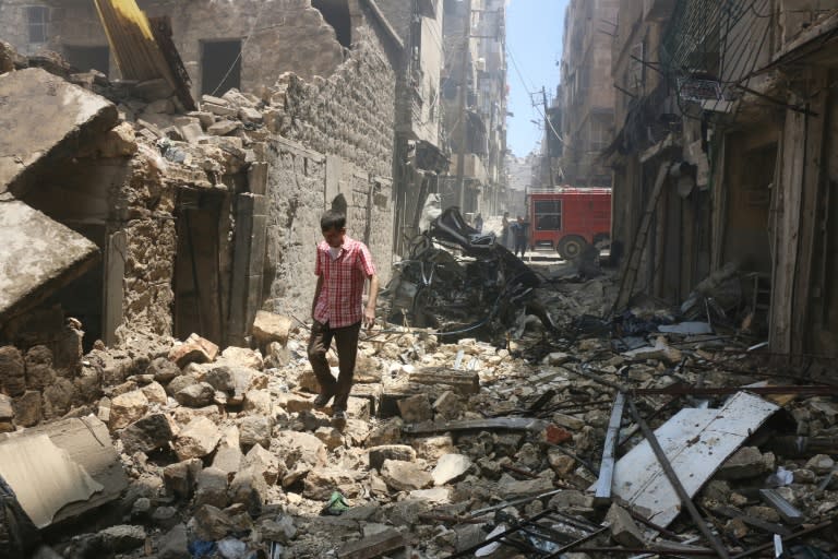 A man walks on the rubble of a destroyed building following reported air strikes by Syrian forces in the rebel-held Al-Shaar neighbourhood of Aleppo, on June 8, 2016