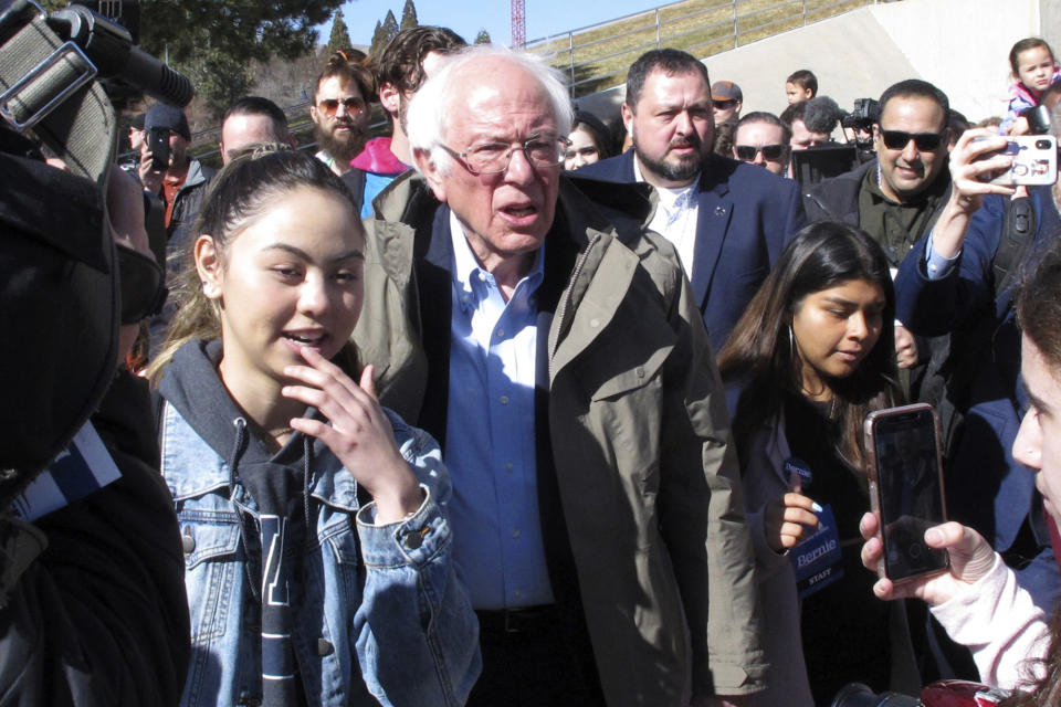 Democratic presidential candidate U.S. Sen. Bernie Sanders, I-Vt., capped a speech to hundreds of people on the campus of the University on Nevada, Reno, Tuesday, Feb. 18, 2020, by leading several dozen on a two-block march to the student union to cast their ballot on the final day of early voting ahead of Saturday's presidential caucuses. Sanders accused billionaire rival Mike Bloomberg for trying to buy the Democratic nomination and said his own campaign is the campaign for working class people. (AP Photo/Scott Sonner)