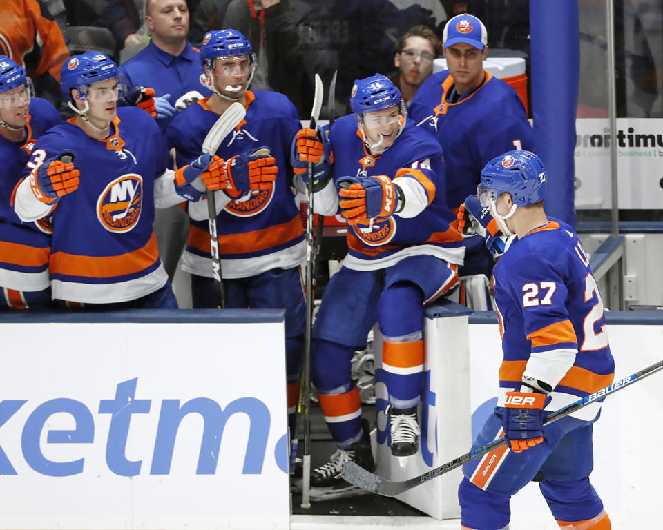 Teammates congratulate New York Islanders left wing Anders Lee (27) after Lee scored a goal against the Colorado Avalanche during the third period of an NHL hockey game, Monday, Jan. 6, 2020, in Uniondale, N.Y. The Islanders defeated the Avalanche 1-0 on Lee's goal. (AP Photo/Kathy Willens)