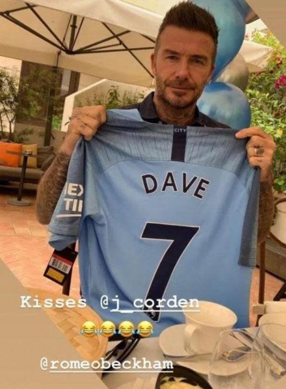 Beckham is shown holding up a Manchester City shirt (Victoria Beckham / Instagram)