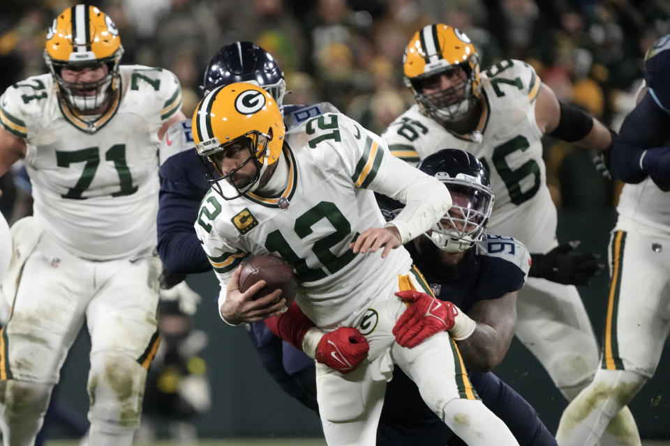 Green Bay Packers quarterback Aaron Rodgers (12) is sacked by Tennessee Titans defensive tackle Jeffery Simmons (98) during the second half of an NFL football game Thursday, Nov. 17, 2022, in Green Bay, Wis. (AP Photo/Morry Gash)