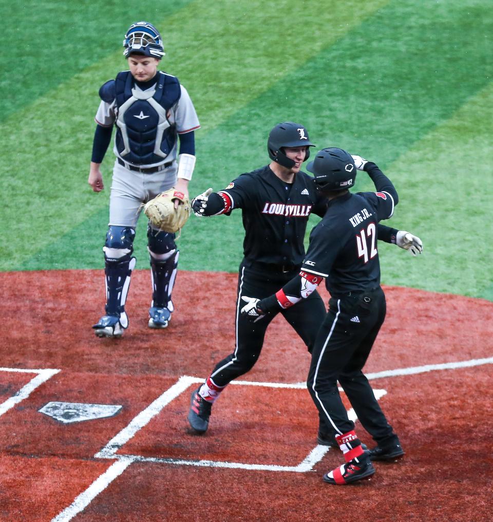 Louisville's Ryan McCoy celebrates after hitting a two-run homer against Bucknell on Feb. 17, 2023.