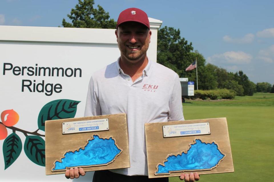 Eastern Kentucky University men’s golf head coach Justin Tereshko poses for a photo with both the low amateur and tournament champion plaques after winning the 104th Kentucky Open last week at Persimmon Ridge Golf Club in Louisville. Tereshko also won Kentucky’s State Amateur Championship this summer, and is just the fourth person to win both tournaments in the same year.