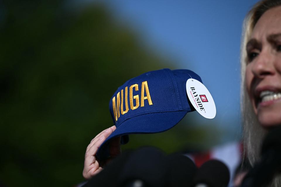 Rep. Marjorie Taylor Greene, R-Ga., holds a "Make Ukraine Great Again" hat during a press conference on House Democratic Leader Hakeem Jeffries' endorsement of Republican House Speaker Mike Johnson, outside the Capitol in Washington on Wednesday