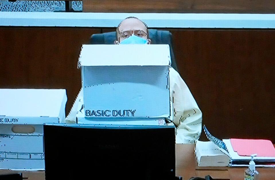 Darrell Brooks makes a fort with boxes during his murder trial (The Milwaukee Journal Sentinel)