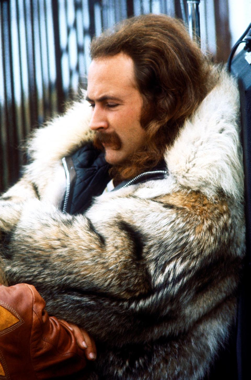 David Crosby looks on in a fur coat during the Big Sur Folk Festival in 1969 (Getty Images)