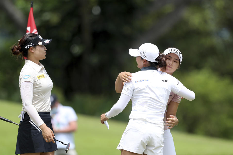 Jin Young Ko of South Korea, center, is congratulated by Jeongeun Lee, right, of South Korea and In Gee Chun of South Korea after winning the Women's World Championship golf tournament at Sentosa Golf Club in Singapore, Sunday, March 6, 2022. (AP Photo/Paul Miller)