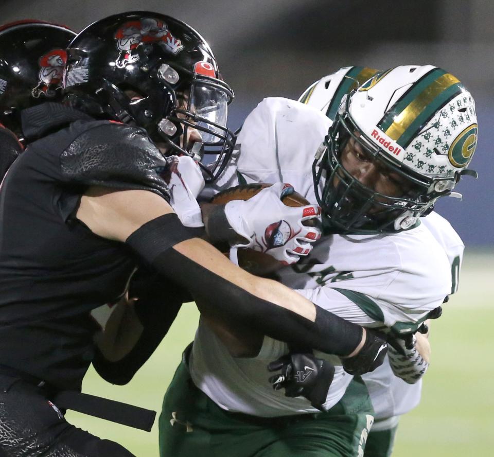 GlenOak's Jamar Johnson tries to run through McKinley's Alex Vazquez during a first-round playoff game, Friday, Oct. 28, 2022.