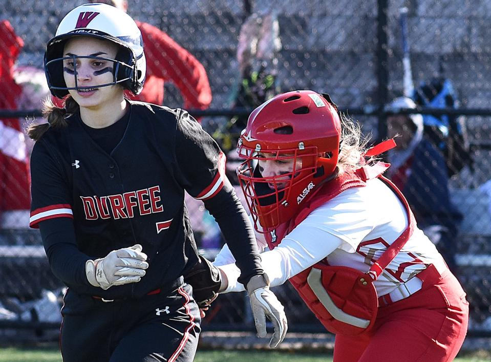 Bishop Connolly catcher Morgan Diogo tags out Durfee's Mia Jacob in Wednesday's season opener at Kuss Middle School in Fall River.