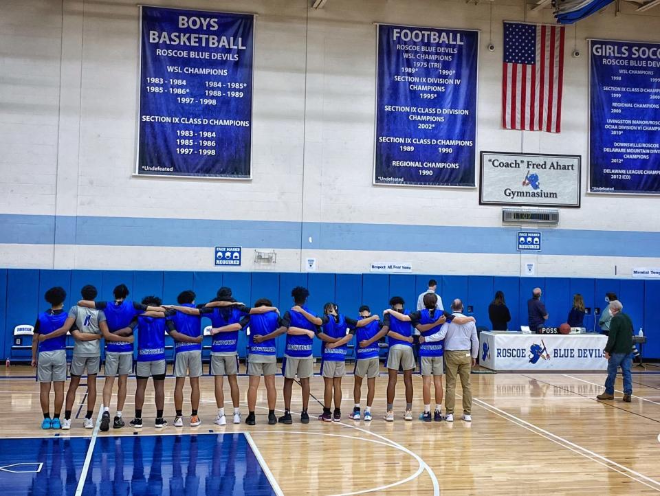 The Monticello boys basketball team faces the banner in the "Coach" Fred Ahart Gymnasium during the first annual Fred Ahart Foundation Games in Roscoe on Jan. 15. (Photo provided by: Cheynne Smith).
