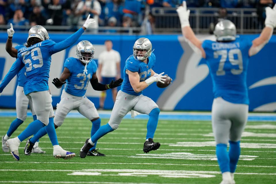 Teammates react after Detroit Lions defensive end Aidan Hutchinson intercepted a pass during the first half of an NFL football game against the Chicago Bears, Sunday, Jan. 1, 2023, in Detroit. (AP Photo/Paul Sancya)