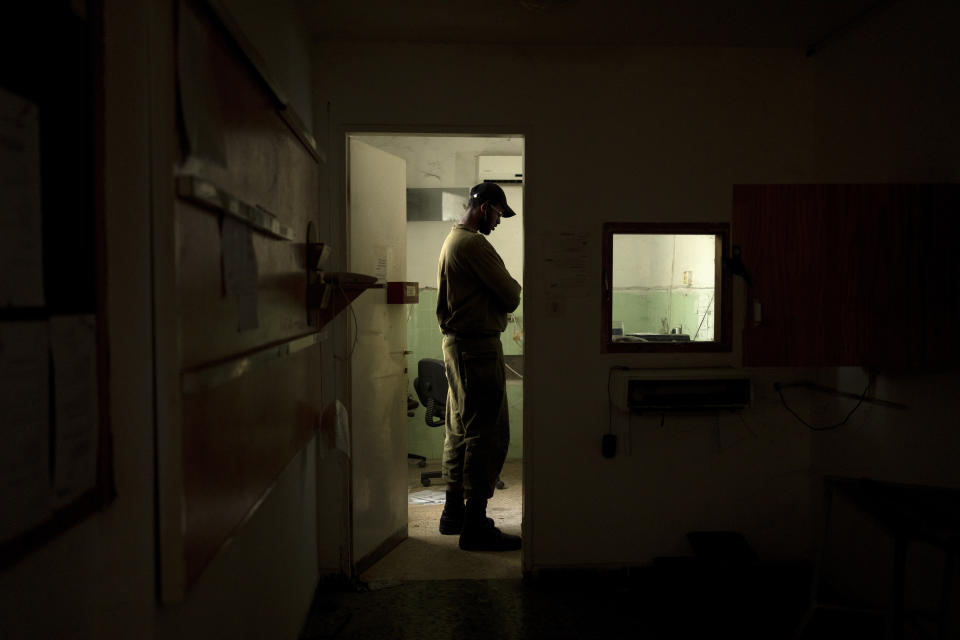 An Israeli soldier visits the the communal dining hall at Kibbutz Nir Oz in southern Israel during a Passover seder event for hostages held in Gaza on Thursday, April 11, 2024, where a quarter of all residents of the kibbutz were killed or captured by Hamas on Oct. 7, 2023. (AP Photo/Maya Alleruzzo)