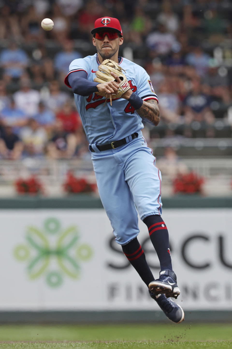 Minnesota Twins shortstop Carlos Correa throws the ball to first baseman Jose Miranda for an out after Tampa Bay Rays' Ji-Man Choi hit a ground ball during the first inning of a baseball game Sunday, June 12, 2022, in Minneapolis. (AP Photo/Stacy Bengs)