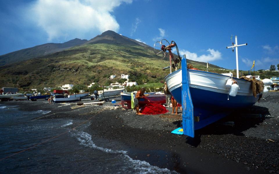 Fishing boats on the beach on the island of Stromboli. - Credit: Alamy