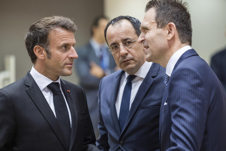 France's President Emmanuel Macron, left, speaks with Cypriot President Nikos Christodoulides, second right, and Slovakia's Prime Minister Ludovit Odor during a round table meeting at an EU summit in Brussels, Thursday, June 29, 2023. European leaders meet for a two-day summit to discuss Ukraine, migration and the economy. (AP Photo/Geert Vanden Wijngaert)