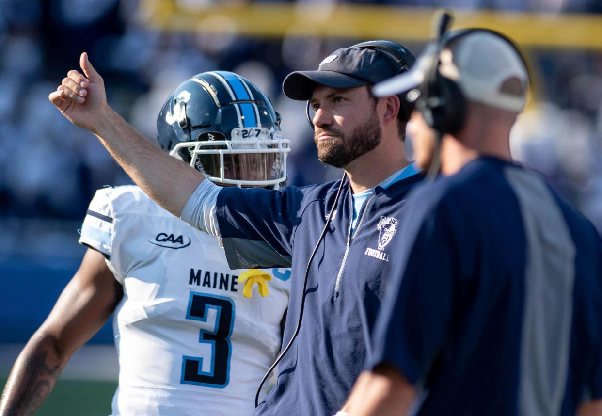 Maine coach Nick Charlton calls to players at the start of a timeout during the first half of the team's NCAA football game against James Madison in Harrisonburg, Va., Saturday, Sept. 11, 2021. (Daniel Lin/Daily News-Record via AP)