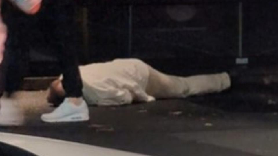 The alleged victim appears to lie unconscious on the pavement after the alleged choking assault. Picture: Supplied