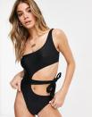 We see no flaws in this midriff-baring number. Start manifesting it into your suitcase. $57, ASOS. <a href="https://www.asos.com/us/candypants/candypants-one-shoulder-tie-swimsuit-in-black/prd/14900626?" rel="nofollow noopener" target="_blank" data-ylk="slk:Get it now!;elm:context_link;itc:0;sec:content-canvas" class="link ">Get it now!</a>