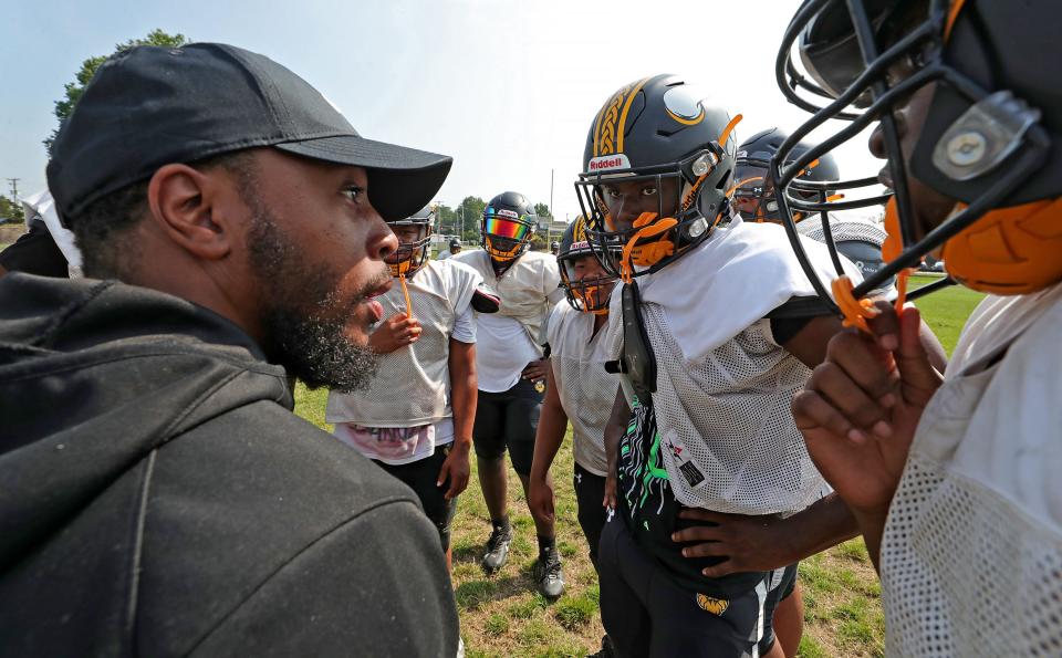 North coach DeMonte Powell, left, speaks to his players before practice on Aug. 3.