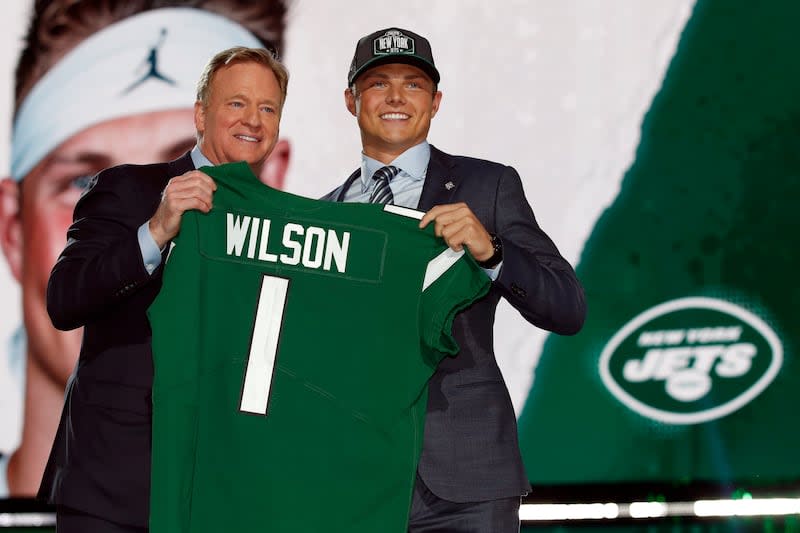 Zach Wilson holds a New York Jets jersey with NFL commissioner Roger Goodell after being selected by the team in the first round of the NFL draft, Thursday, April 29, 2021