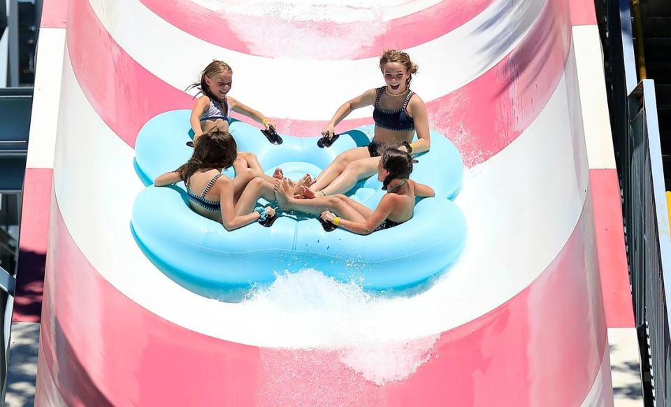 Triple-digit temperatures Saturday in Paso Robles bring people out to cool off at The Ravine water park. Allyson Jennings, 9, Brynn Gause, 9, Aubrey Fitts, 13, and Drew Gause, 12, all from Bakersfield, enjoy a ride down Thunder Run, a large slide at the park.
