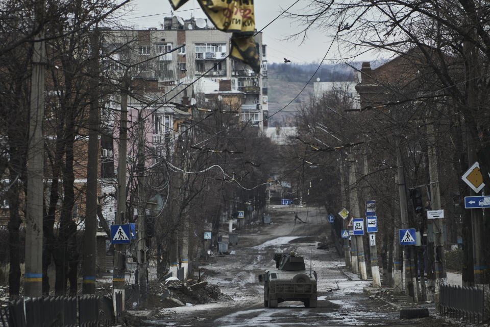 FILE - Ukrainian soldiers ride in a Humvee in Bakhmut, Donetsk region, Ukraine, Wednesday, Dec. 21, 2022. (AP Photo/Libkos, File)