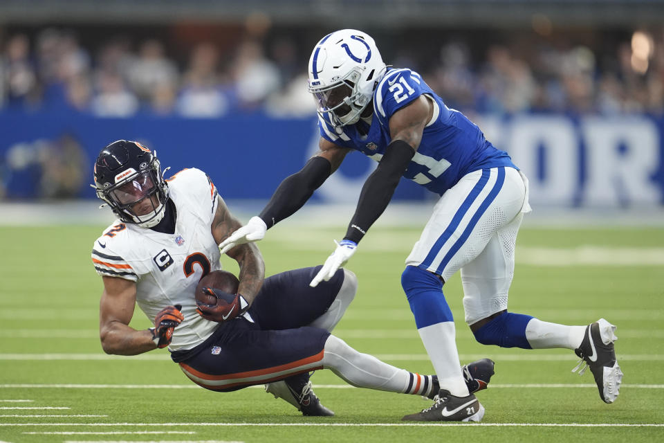 Chicago Bears wide receiver DJ Moore (2) is stopped by Indianapolis Colts cornerback Dallis Flowers (21) after a catch during the first half of an NFL football game Sunday, Sept. 22, 2024, in Indianapolis. (AP Photo/Michael Conroy)