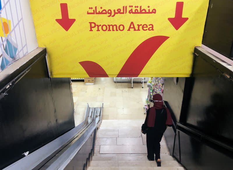 A woman walks down the stairs to a promotional area inside a supermarket in Beirut