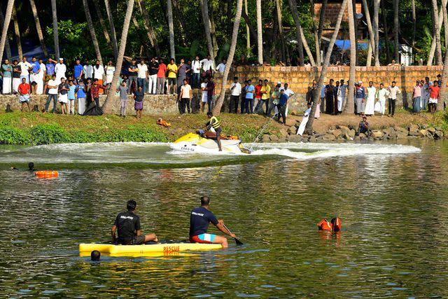 P.P. Afthab/AP Photo Rescuers in a boat searching waters after tourist boat capsized