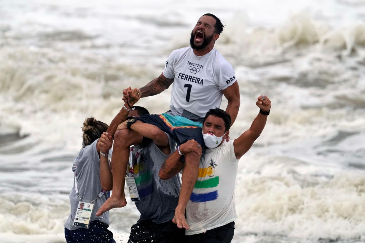 Brazil's Italo Ferreira screams after winning the gold medal in the men's surfing competition at the 2020 Summer Olympics, Tuesday, July 27, 2021, at Tsurigasaki beach in Ichinomiya, Japan.