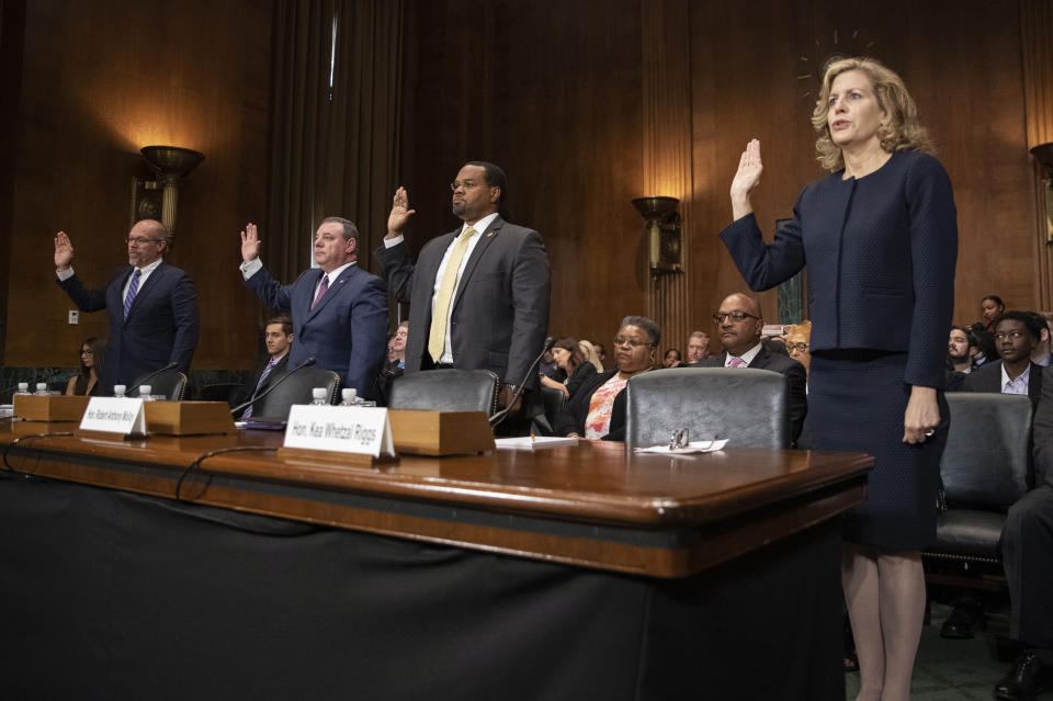 FILE - From left, nominees Douglas Russell Cole and Matthew Walden McFarland to be U.S. District Judges for the Southern District of Ohio; Robert Anthony Molloy to be District Court of the Virgin Islands Judge; and Kea Whetzal Riggs to be U.S. District Judge for the District of New Mexico are sworn in during a Senate Judiciary Committee nominations hearing on Capitol Hill in Washington, June 26, 2019. (AP Photo/Manuel Balce Ceneta, File)