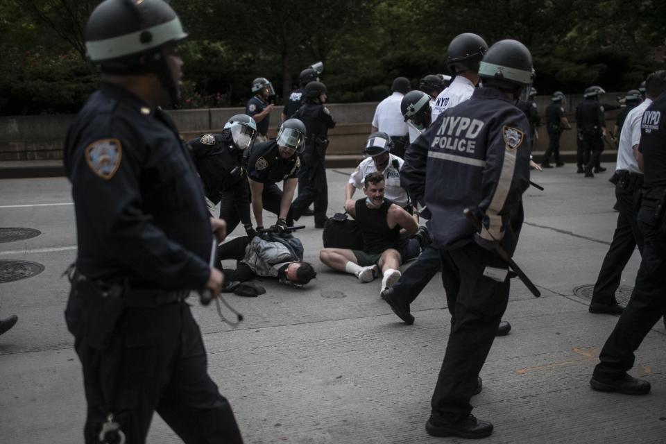 Police arrest protesters refusing to get off the streets during an imposed curfew while marching in a solidarity rally calling for justice regarding the death of George Floyd, Tuesday, June 2, 2020, in New York. Floyd died after being restrained by Minneapolis police officers on May 25. (AP Photo/Wong Maye-E)