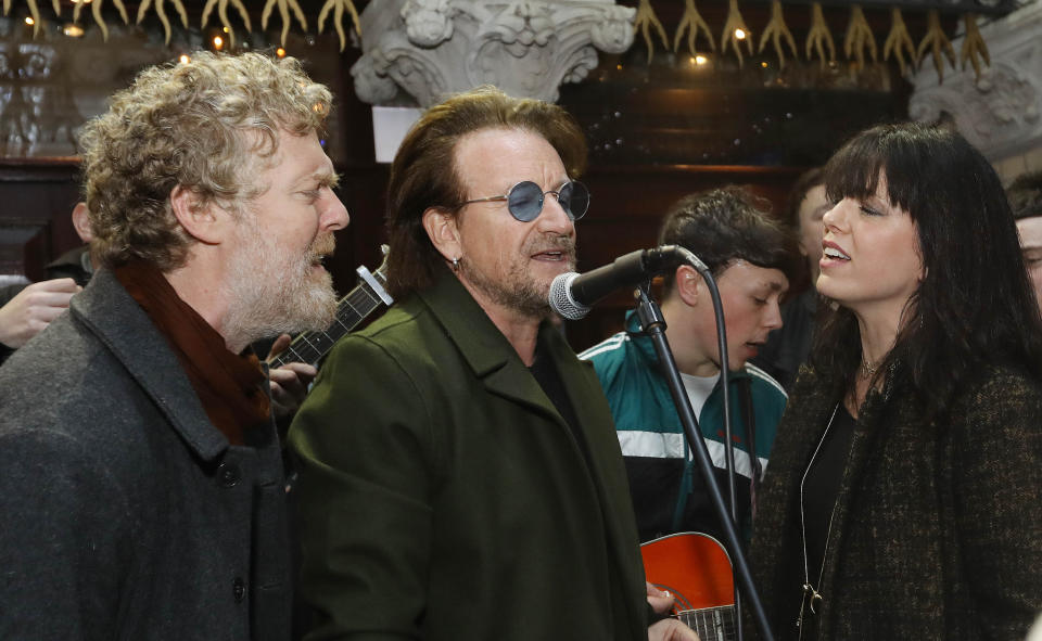 Glen Hansard, Bono and Imelda May take part in the annual Christmas Eve busk on Grafton Street, Dublin.