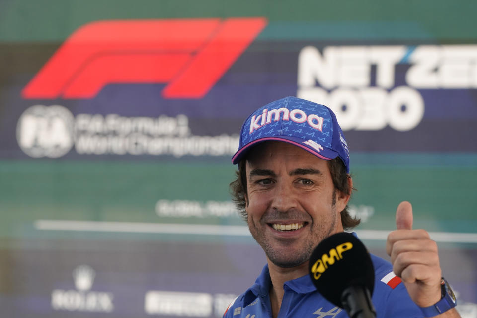 Alpine driver Fernando Alonso, of Spain, reacts after an interview at the Formula One U.S. Grand Prix auto race at Circuit of the Americas, Thursday, Oct. 20, 2022, in Austin, Texas. (AP Photo/Darron Cummings)