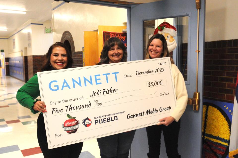 USA Today Network Account Executive Nicole Valdez (left) and Kristyn White Davis (right) of CSU Pueblo pose with a $5,000 Amazing Teacher Award check given to Bessemer Academy Teacher Jodi Fisher (center).