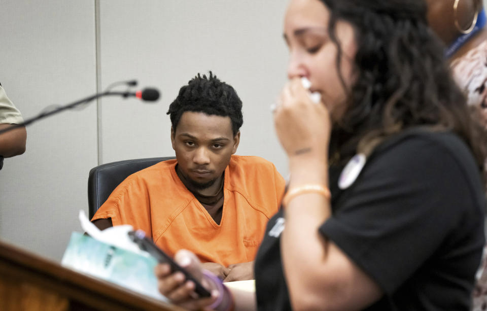 D’Pree Shareef Robinson listens as stepmother Korrina Smith reads letters from Trinity Ottoson-Smith's friends about what her loss means to them Tuesday, July 11, 2023, in Minneapolis. Robinson was sentenced Tuesday to more than 37 years in prison for fatally shooting a 9-year-old Minnesota girl as she was jumping on a trampoline with friends. Robinson pleaded guilty in March to second-degree murder in the 2021 death of Ottoson-Smith. He later tried unsuccessfully to withdraw the guilty plea. (Glen Stubbe/Star Tribune via AP, Pool)